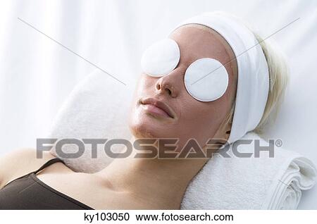 Portrait of a young woman with beauty mask on her face and cleansing cotton on her eyes View Large Photo Image Stock Image - Portrait of a young woman with beauty mask on her face and cleansing cotton on her eyes. Fotosearch