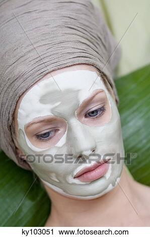 Portrait of a young woman with beauty mask on her face View Large Photo Image Stock Image - Portrait of a young woman with beauty mask on her face. Fotosearch