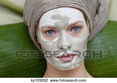 Portrait of a young woman with beauty mask on her face View Large Photo Image Stock Image - Portrait of a young woman with beauty mask on her face. Fotosearch