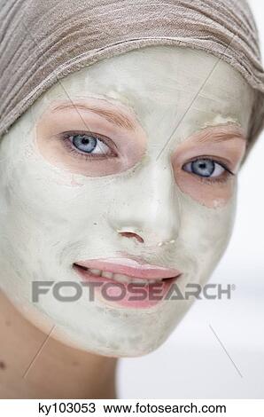 Portrait of a young woman with beauty mask on her face View Large Photo Image Stock Image - Portrait of a young woman with beauty mask on her face. Fotosearch