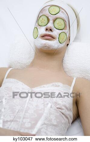 Portrait of a young woman with beauty mask on her face and slices cucumber on her eyes View Large Photo Image Stock Photo - Portrait of a young woman with beauty mask on her face and slices cucumber on her eyes. Fotosearch