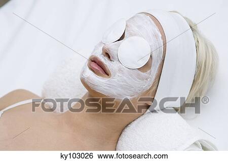 Portrait of a young woman with beauty mask on her face and cleansing cotton on her eyes View Large Photo Image Stock Photograph - Portrait of a young woman with beauty mask on her face and cleansing cotton on her eyes. Fotosearch