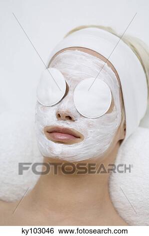 Portrait of a young woman with beauty mask on her face and cleansing cotton on her eyes View Large Photo Image Stock Photograph - Portrait of a young woman with beauty mask on her face and cleansing cotton on her eyes. Fotosearch