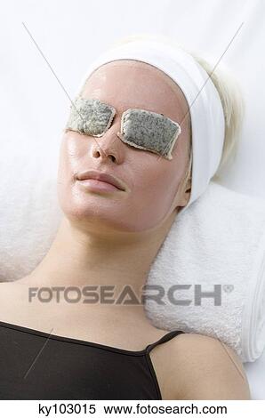 Portrait of a young woman with beauty mask on her face and herbs bags on her eyes View Large Photo Image Stock Photography - Portrait of a young woman with beauty mask on her face and herbs bags on her eyes. Fotosearch