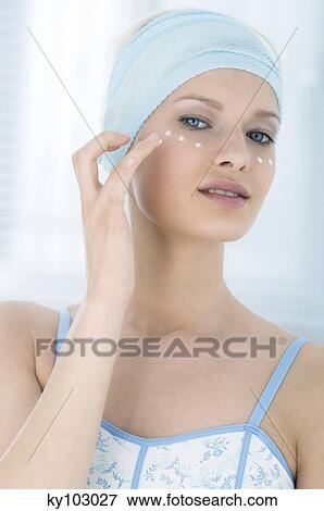Young Woman face looking at the camera, drops of cream under her eyes, close-up (studio) View Large Photo Image Stock Photo - Young Woman face looking at the camera, drops of cream under her eyes, close-up (studio). Fotosearch