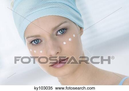 Young Woman face looking at the camera, drops of cream under her eyes, close-up (studio) View Large Photo Image Stock Photography - Young Woman face looking at the camera, drops of cream under her eyes, close-up (studio). Fotosearch
