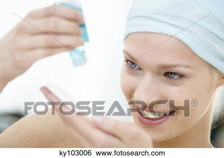 Young Woman face pouring on lotion in her hand, close-up (studio) View Large Photo Image Stock Photograph - Young Woman face pouring on lotion in her hand, close-up (studio). Fotosearch