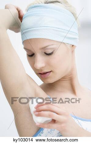 Young Woman face using roll-on deodorant View Large Photo Image Picture - Young Woman face using roll-on deodorant. Fotosearch