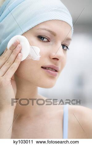 Young Woman face with make up, holding a cleansing cotton (studio) View Large Photo Image Stock Image - Young Woman face with make up, holding a cleansing cotton (studio). Fotosearch