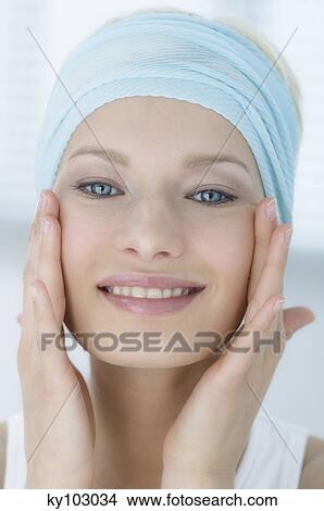 Young Woman face with make up, looking a the camera, figers on her face, close-up (studio) View Large Photo Image Picture - Young Woman face with make up, looking a the camera, figers on her face, close-up (studio). Fotosearch