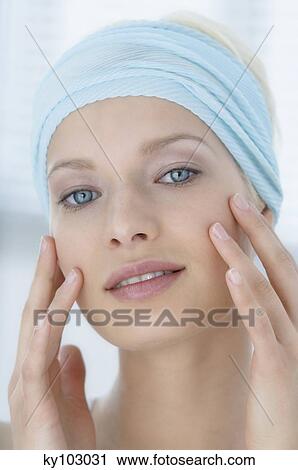 Young Woman face with make up, looking at the camera, fingers on her face, close-up (studio) View Large Photo Image Stock Image - Young Woman face with make up, looking at the camera, fingers on her face, close-up (studio). Fotosearch