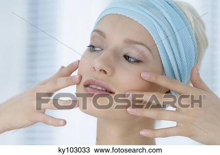 Young Woman face with make up, putting her figers on her face, close-up (studio) View Large Photo Image Stock Image - Young Woman face with make up, putting her figers on her face, close-up (studio). Fotosearch