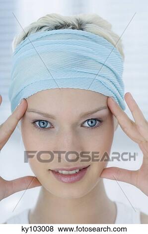 Young Woman looking at the camera, fingers on her temples (studio) View Large Photo Image Stock Photo - Young Woman looking at the camera, fingers on her temples (studio). Fotosearch
