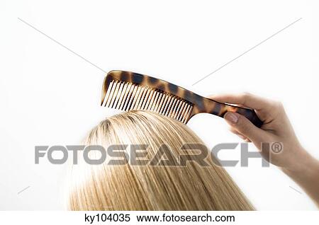 Portrait of a young woman combing her hair, close up, studio View Large Photo Image Stock Photography - Portrait of a young woman combing her hair, close up, studio. Fotosearch