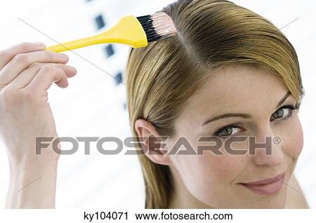 Portrait of a young woman dyeing her hair, little brush in her hand View Large Photo Image Stock Image - Portrait of a young woman dyeing her hair, little brush in her hand. Fotosearch