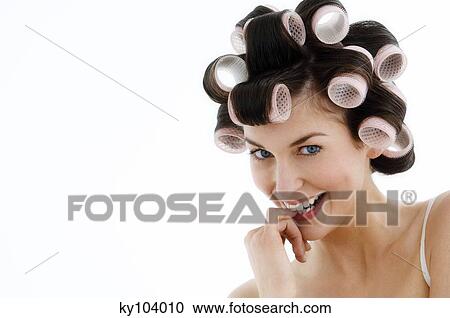 Portrait of a young woman in curlers, close up (studio) View Large Photo Image Stock Image - Portrait of a young woman in curlers, close up (studio). Fotosearch