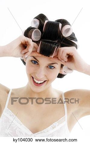 Portrait of a young woman in curlers, close up (studio) View Large Photo Image Stock Image - Portrait of a young woman in curlers, close up (studio). Fotosearch