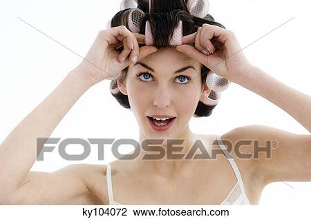 Portrait of a young woman in curlers, close up (studio) View Large Photo Image Stock Image - Portrait of a young woman in curlers, close up (studio). Fotosearch