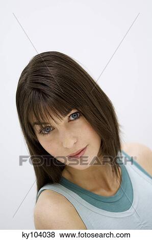 Portrait of a young woman looking at the camera, close up (studio) View Large Photo Image Stock Photo - Portrait of a young woman looking at the camera, close up (studio). Fotosearch
