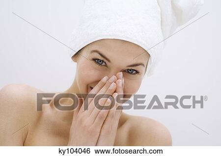 Portrait of a young woman looking at the camera, white hand towel on her head View Large Photo Image Stock Photograph - Portrait of a young woman looking at the camera, white hand towel on her head. Fotosearch