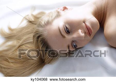 Portrait of a young woman lying, long hair on floor View Large Photo Image Stock Photo - Portrait of a young woman lying, long hair on floor. Fotosearch