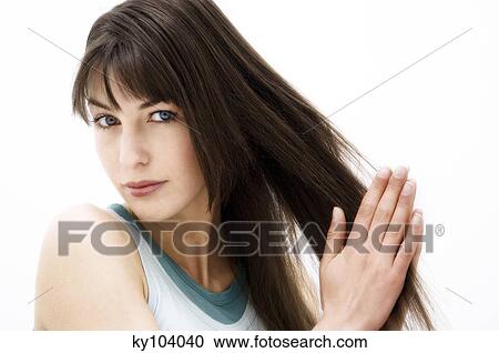 Portrait of a young woman rubbing her hair (studio) View Large Photo Image Stock Image - Portrait of a young woman rubbing her hair (studio). Fotosearch