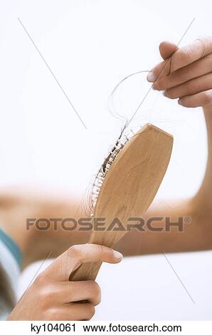 Young woman holding a brush hair, close up (studio) View Large Photo Image Stock Image - Young woman holding a brush hair, close up (studio). Fotosearch