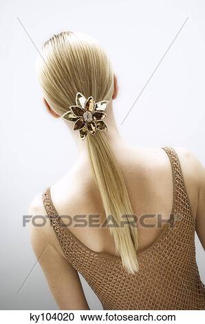 Young woman, view from the back, slide in her blond hair (studio) View Large Photo Image Stock Image - Young woman, view from the back, slide in her blond hair (studio). Fotosearch
