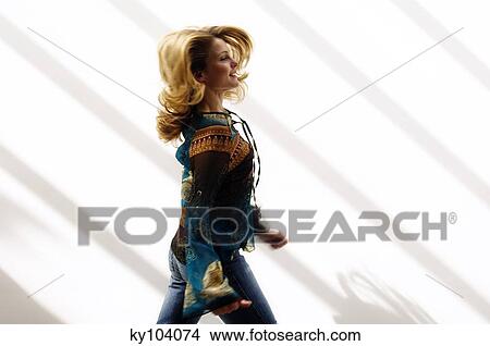 Young woman walking, blurred motion, inside View Large Photo Image Picture - Young woman walking, blurred motion, inside. Fotosearch