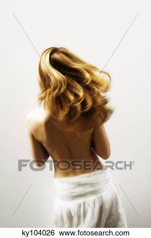 Young woman with blond hair, view from the back, blurred motion (studio) View Large Photo Image Stock Photograph - Young woman with blond hair, view from the back, blurred motion (studio). Fotosearch