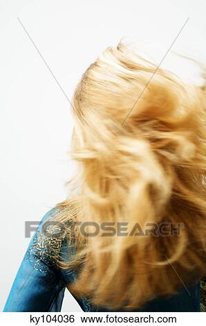 Young woman with blond hair, view from the back, blurred motion, close up (studio) View Large Photo Image Stock Photograph - Young woman with blond hair, view from the back, blurred motion, close up (studio). Fotosearch