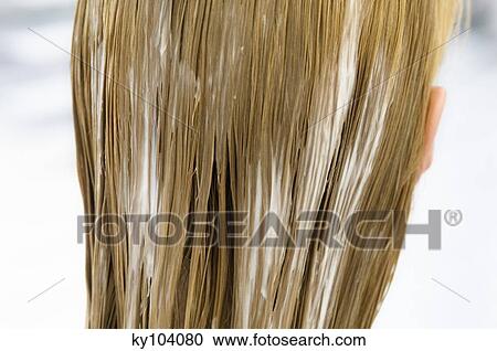 Stock Image - Young woman with hair mask, view from the back, close up (studio). Fotosearch
