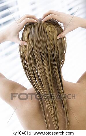 Young woman with long wet hair, view from the back, close up (studio) View Large Photo Image Stock Photography - Young woman with long wet hair, view from the back, close up (studio). Fotosearch