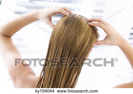 Young woman with wet hair, view from the back, close up (studio) View Large Photo Image Picture - Young woman with wet hair, view from the back, close up (studio). Fotosearch