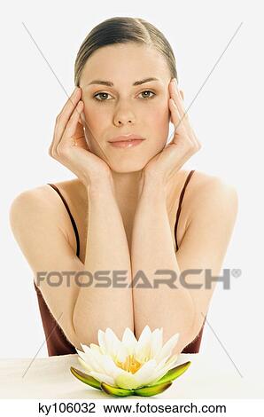 Portrait of a woman in zen attitude, looking at the camera, water lily (studio) View Large Photo Image Stock Image - Portrait of a woman in zen attitude, looking at the camera, water lily (studio). Fotosearch