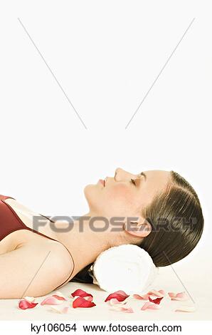 Portrait of a woman relaxing, lying on floor, shut eyes View Large Photo Image Picture - Portrait of a woman relaxing, lying on floor, shut eyes. Fotosearch