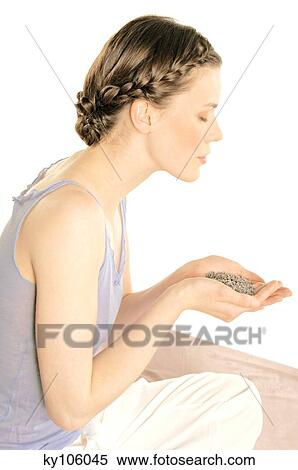 Portrait of a young woman holding grains of lavander, shut eyes View Large Photo Image Stock Photography - Portrait of a young woman holding grains of lavander, shut eyes. Fotosearch