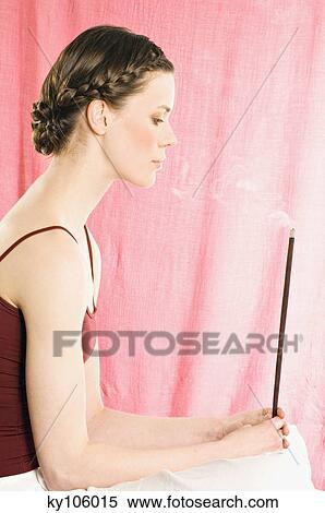 Woman holding incense stick View Large Photo Image Stock Photography - Woman holding incense stick. Fotosearch