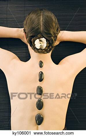 Woman lying, with pebbles on her back, view from above View Large Photo Image Stock Image - Woman lying, with pebbles on her back, view from above. Fotosearch