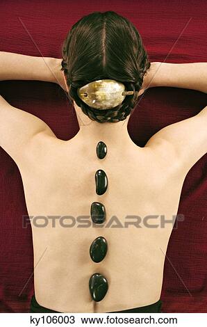 Woman lying, with peebles on her back, view from above View Large Photo Image Stock Image - Woman lying, with peebles on her back, view from above. Fotosearch