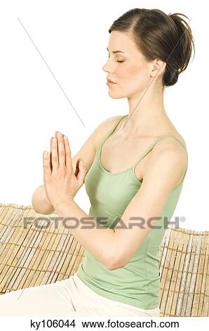 Woman meditating, shut eyes, folded hands View Large Photo Image Picture - Woman meditating, shut eyes, folded hands. Fotosearch