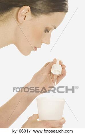 Woman with glass and essential oil View Large Photo Image Stock Photo - Woman with glass and essential oil. Fotosearch