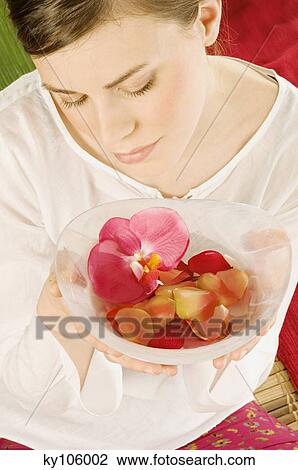 Young woman holding flower petals in a little dish, view from above View Large Photo Image Stock Image - Young woman holding flower petals in a little dish, view from above. Fotosearch