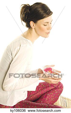 Young woman holding flower petals in a little dish, shut eyes View Large Photo Image Stock Photograph - Young woman holding flower petals in a little dish, shut eyes. Fotosearch