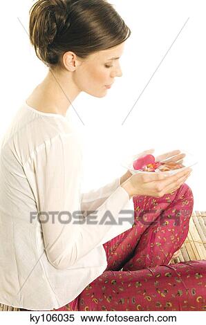 Young woman holding flower petals in a little dish View Large Photo Image Stock Photography - Young woman holding flower petals in a little dish. Fotosearch