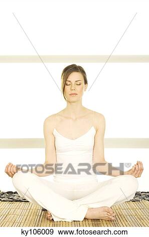 Young woman sitting cross-legged, yoga attitude, shut eyes View Large Photo Image Stock Photo - Young woman sitting cross-legged, yoga attitude, shut eyes. Fotosearch