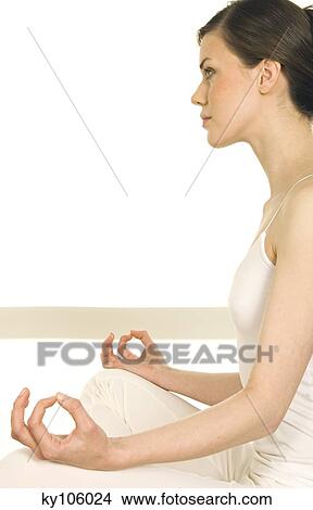 Young woman sitting in profile, yoga attitude View Large Photo Image Picture - Young woman sitting in profile, yoga attitude. Fotosearch