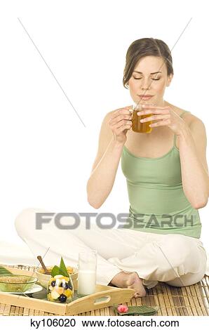 Young woman sitting on bamboo carpet, drinking cup of green tea View Large Photo Image Stock Image - Young woman sitting on bamboo carpet, drinking cup of green tea. Fotosearch