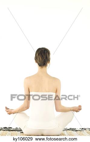 Young woman sitting yoga attitude, view from the back View Large Photo Image Stock Photo - Young woman sitting yoga attitude, view from the back. Fotosearch
