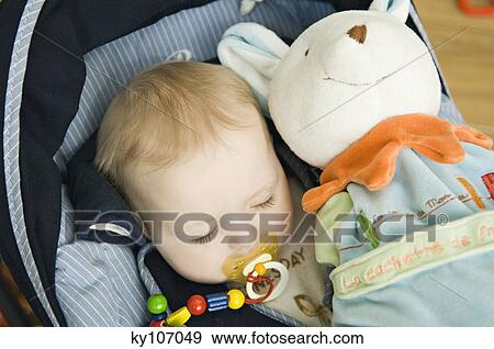 Stock Photo - Baby sleeping, stuffed toy. Fotosearch